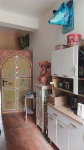 a kitchen with a cabinet and a table in a room at Cool in Cévennes in Le Vigan