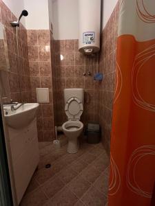 a small bathroom with a toilet and a sink at Just a Hostel in Sozopol +25 photos