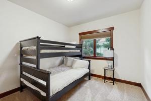 a bedroom with a bunk bed and a window at Blue River Retreat in Silverthorne