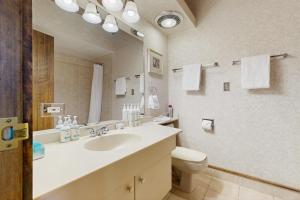 a bathroom with a sink and a toilet and a mirror at Tamarron 773 in Durango +20 photos