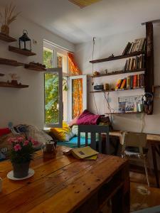 a living room with a wooden table in a room at Just a Hostel in Sozopol