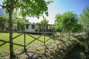 a house in the middle of a field with a fence at Belmonte Ranch in Belmonte Castello