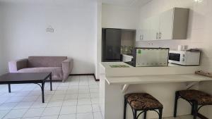 a kitchen with a couch and a table and chairs at Light Hall in Johannesburg +1 photo
