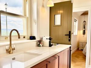 a kitchen with a sink and a window at Luxury cottage for 2 in Castleton - Peak District retreat - Panoramic Views & Log burner in Castleton