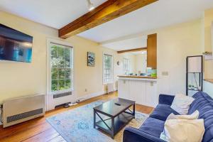 a living room with a blue couch and a table at Stowe Mountain Road Escape in Stowe