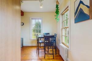 a dining room with a table and chairs at Stowe Mountain Road Escape in Stowe