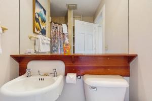 a bathroom with a sink and a toilet and a mirror at Stowe Mountain Road Escape in Stowe +25 photos