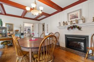 a dining room with a table and a fireplace at Longacre of Appomattox in Appomattox