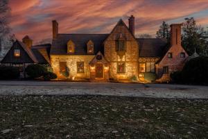 a large house with lights on the front of it at Longacre of Appomattox in Appomattox