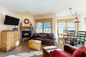 a living room with a couch and a fireplace at Tenderfoot Lodge 2621 in Keystone