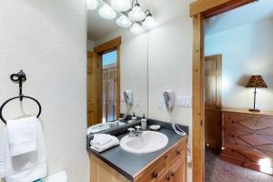 a bathroom with a sink and a mirror at Tenderfoot Lodge 2621 in Keystone +48 photos