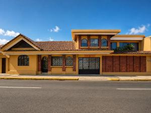 a house on the side of a street at Hotel 1915 INN & SUITES in Alajuela