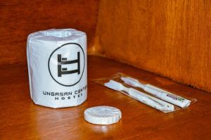 a can of oxy inhaler and three cigarettes on a table at Ungasan Center Hostel in Jimbaran