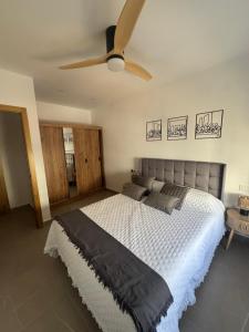 a bedroom with a bed with a ceiling fan at CALIZA y LUZ in Arcos de la Frontera