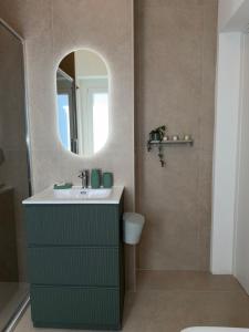 a bathroom with a sink and a mirror at Lungomare 83 in Francavilla al Mare +21 photos