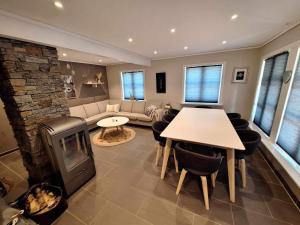a living room with a fireplace and a table and chairs at Aurlandsdalen in Aurland