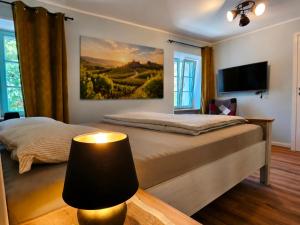 a bedroom with two beds and a tv and a lamp at Old Village House Brda in Kojsko