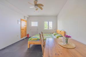 a bedroom with a bed and a table and a fan at Apartments at Frapa in Rogoznica +14 photos