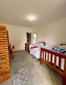 a bedroom with two beds in a room at Pousada Padre Pio CE in São Benedito