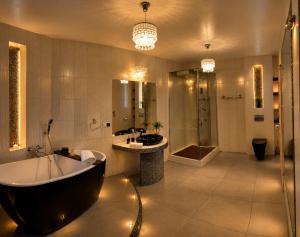 a bathroom with a tub and a sink and a shower at Brzegowy Relaks in Mszana Dolna +21 photos