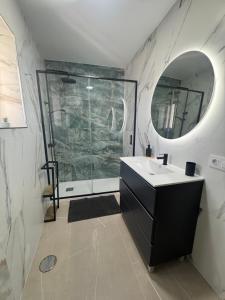 a bathroom with a shower and a sink and a mirror at CALIZA y LUZ in Arcos de la Frontera +13 photos