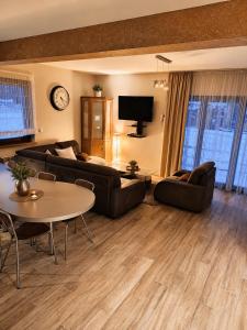 a living room with a couch and a table at Brzegowy Relaks in Mszana Dolna