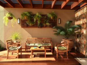 a living room with two chairs and a table at Hotel Matão By Mercure in Matão