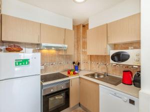 a kitchen with a white refrigerator and a sink at Apartment Vermell-8 by Interhome in Platja d'Aro