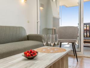 a table with wine glasses and a bowl of strawberries at Apartment Vermell-8 by Interhome in Platja d'Aro