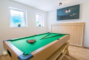a pool table in a living room with at Apartment Nature Beauty in Zagvozd