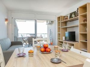 a living room with a table with fruit on it at Apartment Vermell-8 by Interhome in Platja d'Aro