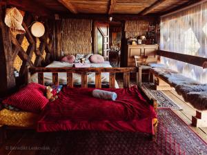 a bedroom with two beds in a log cabin at Hay barn unique experience Visole in Slovenska Bistrica