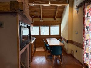 a dining room with a table and a television at Chalet Morier in Demonte