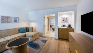 a living room with a couch and a tv at Hilton Phoenix Resort at the Peak in Phoenix