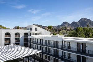 a white building with mountains in the background at Hilton Phoenix Resort at the Peak in Phoenix