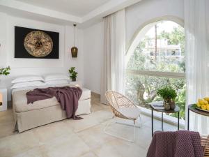 a bedroom with a bed and a large window at Baia Delle Zagare - Handwritten Collection in Mattinata +136 photos