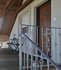 a front door of a house with a wooden door at Green Home Apartman in Nemesvámos