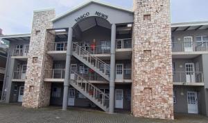 a building with a spiral staircase in front of it at 6 Vasco Mews in Mossel Bay