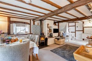 a living room with a table and a fireplace at 2 Bed in Croyde oc-smithc in Croyde