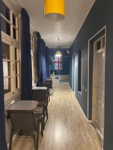 a corridor with chairs and a table in a room at Hostel Room 110 in Tbilisi City