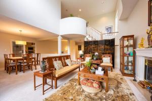 a living room with a couch and a fireplace at Mountain and Ocean Views Art Deco House in West Vancouver