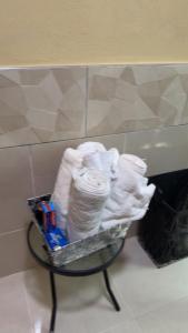 a table with a basket of toilet paper on it at Renee Oasis in Negril