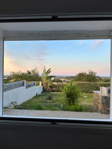 a window view of the ocean from a house at Casa Pace - jardin - 2 chambres - Biguglia in Biguglia