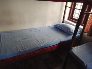 a bed in a room with a window at CK Enclave in Tripunittura