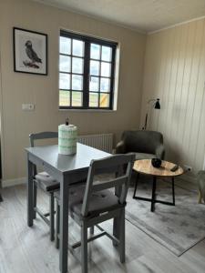 a living room with a table and a chair at Akrar guesthouse in Hella