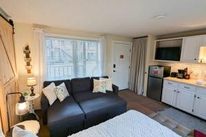 a living room with a couch and a kitchen at Dream Weaver in Ludlow +29 photos