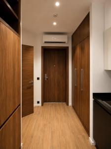 a hallway with wooden cabinets and a door at White Villas in Nardaran
