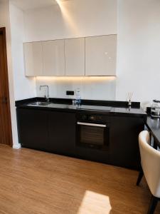 a kitchen with a sink and a stove at White Villas in Nardaran