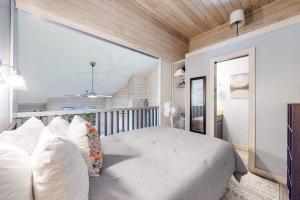 a bedroom with a large white bed with white pillows at Elkhorn Studio Condo - The Clocktower in Sun Valley