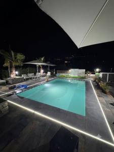 a large swimming pool at night at Paradise House in Maratea